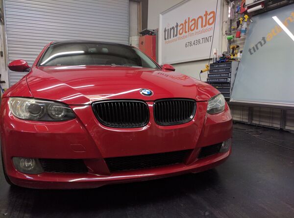 Red BMW Coupe front view with dark window tint by TintButler
