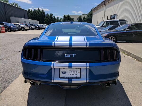 Blue Ford Mustang GT with racing stripes and tinted windows Gainesville